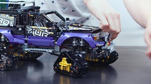 Experience the ultimate in traction and maneuverability with the Extreme Adventure vehicle, featuring 4 high-grip tracks with working suspension, upswing doors with lowering running board function, raisable roof tent, working winch, front steering, opening hood, detailed V8 engine with moving pistons and a lockable tailgate. Also includes a sliding storage drawer, side storage compartment with a first aid kit and 2 fire extinguishers, and a roof rack with 2 jerry cans in a rare dark-green color.