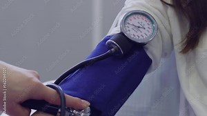 young doctor Measurea blood pressure to a woman patient