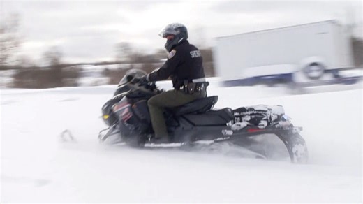 Police ride snowmobiles as winter storm hits North America