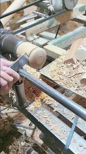 Woodturner Skillfully Parting a Piece on the Lathe