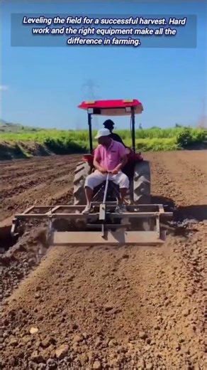 Farmer expertly levels soil, preparing field for planting season.
