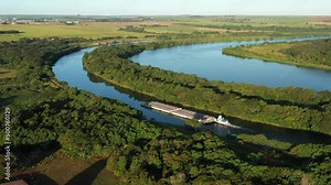 grain barge going up the tiete-parana waterway, on the tiete river