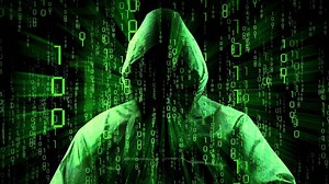Computer Hacker with Matrix Style Binary Code in Background - Digital Data Safety Concept