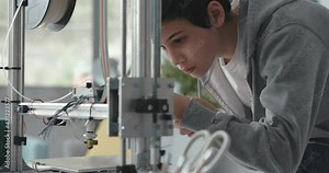 Smart student using a 3D printer in the lab