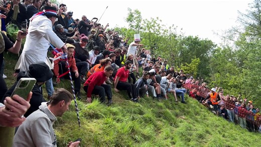 Gloucestershire cheese rolling attracts thousands to Coopers Hill