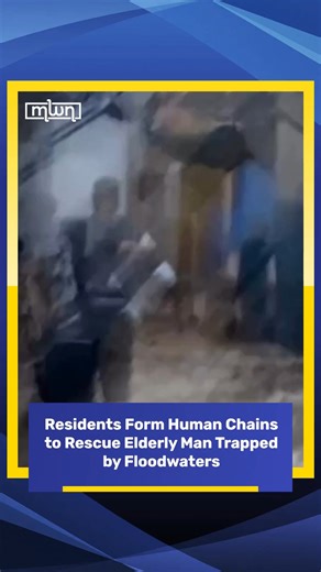 Morocco World News on Instagram: "Residents of a flooded neighborhood were seen attempting to rescue an elderly man after rising waters left him stranded, as heavy rainfall continued to batter the area. Footage circulating online shows citizens forming human chains, gripping one another’s arms as they moved through the current to reach the man and help guide him to safety. The improvised rescue effort reflected a strong sense of solidarity, with neighbors acting quickly and collectively in the f
