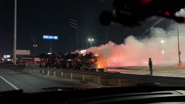 18-wheeler hauling cars engulfed in flames along Houston freeway