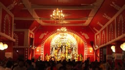 view of vibrant durga pooja display with idols of durga and god...