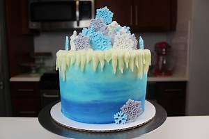 Winter is such a magical time of year, I thought it deserved a cake!! This winter wonderland cake is made with a checkerboard pattern inside, and is decorated with cream cheese icicles and fondant snowflakes. The recipes for my layer cake and cream cheese frosting are up on chelsweets.com!! | Chelsweets