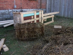 A hand-powered hay and leaf baler
