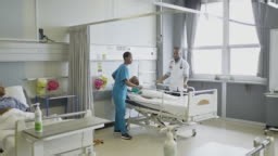 Real time video of patient being moved to surgery by medical...