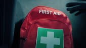 First aid backpack is picked up or put down