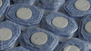 Dishwasher tablets background rotating macro. Detergents concept