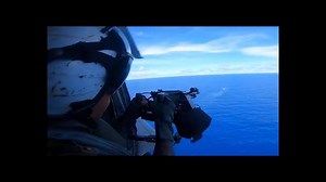 Navy Helicopter Gunner Fires M240 Machine Gun Over the Ocean