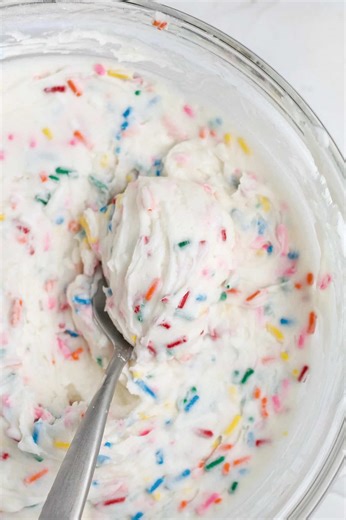 This Funfetti Frosting is a homemade vanilla frosting that is creamy, sweet and loaded with rainbow sprinkles! This frosting recipe takes 5 minutes to make, only requires 5 ingredients and has zero milk of any kind! It's gluten free, eggless, nut free and can easily be vegan! https://laneandgreyfare.com/funfetti-frosting/