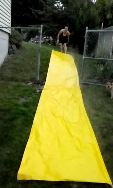 Woman Continuously Fails at Slip N Slide
