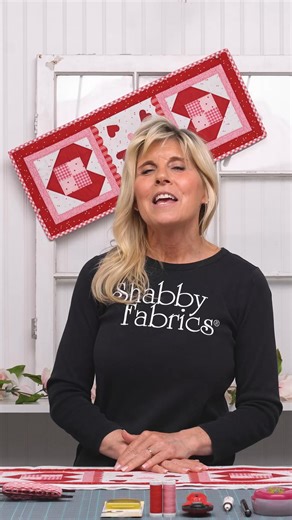 Celebrate the year in style with the Shabby Fabrics Sew Cute Runner Series. The February runner features two charming patchwork heart blocks framing a center panel filled with tossed pre-fused laser-cut appliqué hearts, bordered by sweet scalloped edges. Bursting with cheerful Valentine’s Day colors, this runner is a delightful way to add a pop of color and seasonal charm to your home. | Shabby Fabrics