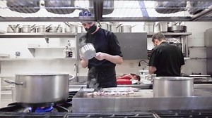 Diverse group of chefs preparing food in restaurant kitchen. Working in a busy restaurant kitchen. High quality FullHD footage