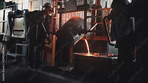 Steelmaker works in a foundry. Liquid metal in furnace. Liquid metal production