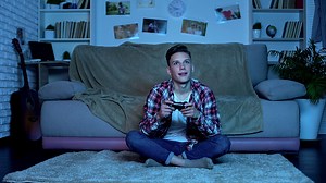 Teenage boy playing video game late at night addiction, lack of...