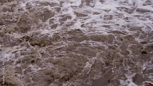 Bubbling Mud Flow. Powerful streams of dirty water after heavy rain. Slow Motion