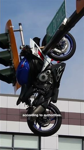Motorcycle flips onto traffic light after crash in Canada