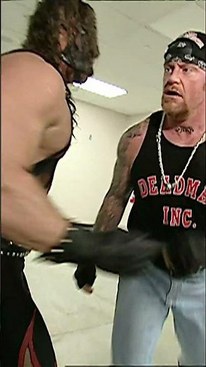 Undertaker brutalizes Shane McMahon in the backstage area before being restrained by Kane