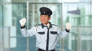 Male security guard dancing at the building entrance