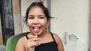 Cute Little Girl Eating Lollipop Candy Footage.