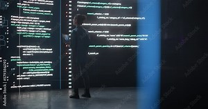 Portrait of Young Woman Working on Laptop Computer, Looking at Big Digital Screen Displaying Back-end Code Lines. Professional Programmer Developing a Big Data Interface Software Project