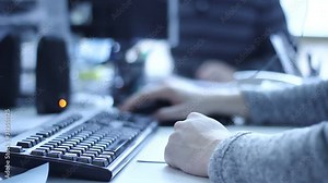 Workers working in the office, using computers. Close up.