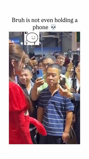 Socion on Instagram: "The Instagram reel features a short video from an auto show where a crowd films a woman in a red dress entering a car, but one man stares intently without a phone, prompting the caption highlighting the absurdity. , a account specialising in viral clips, it has amassed over 20,000 likes and 1.1 million views in two days, tapping into relatable humour about distracted admiration. Replies amplify the comedy, with users joking about the man's 'photographic memory' or mental re