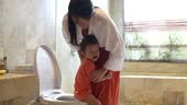 video of a little boy learning to use toilet amenities with a little...