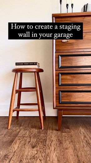 Erin Shuford • DIY Furniture Flips • MCM Refinishing on Instagram: "Do you struggle with your background while staging? Level up your photos and videos with a staging wall! I got everything from @loweshomeimprovement ! Here is what I used: ➡️ STAINMASTER Willow Creek Hickory Wood Look 12-ft W x Cut-to-Length Sheet Vinyl ➡️ Loctite Power Grab Ultimate in Clear ➡️ ReliaBilt 1/2-in x 3.25-in x 8-ft Primed MDF Baseboard Moulding ➡️ Sherwin Williams Interior paint in the color Dover ➡️ DAP white caul