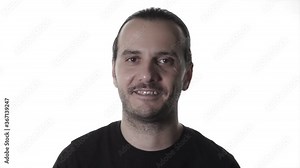Handsome happy guy is dancing on indoor, white background in studio shot. Trendy cool man portrait