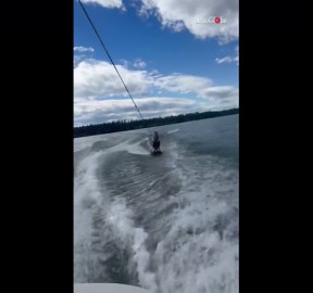 Girl gives knee boarding a go and fails to stay up on the board