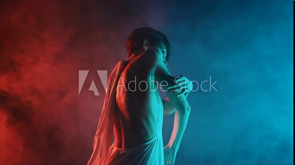 Gorgeous flexible woman with bare back performing amazing modern choreography - elegant contemporary style dance in dark studio. Freestyle hands movements
