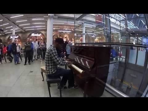 LONDON: UK - EPIC PUBLIC PIANO PLAYER AT ST PANCRAS STATION