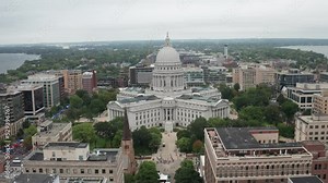 Wisconsin state capitol building in Madison, Wisconsin with drone video on the side with medium shot moving forward.