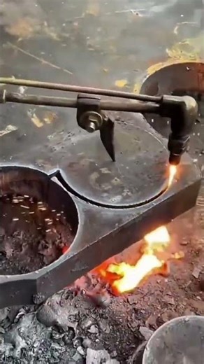 Oxygen acetylene torch cutting heavy steel plate into a round shape
