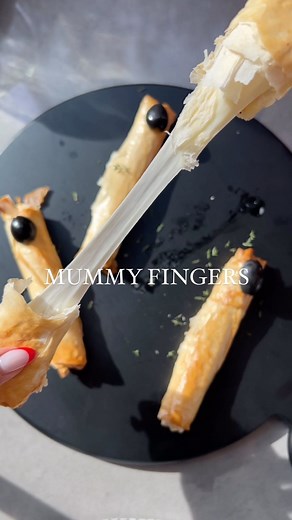 Nicolle Laviolette on Instagram: "RECIPE HERE ⬇️✨ Mummy fingers are the perfect easy appetizer to serve this Halloween for all your spooky get togethers 👻🎃 What you’ll need: 🧀 phyllo dough 🧀 mozzarella string cheese 🧀 one egg (egg wash) 🧀 black olives 🧀 marinara sauce (optional for dipping in) Set oven to 375 F. On a baking sheet, lay out 2 sheets of phyllo dough and wrap your mozzarella string cheese in it (be sure to tuck in the edges while you roll it so no cheese oozes out). Wrap up a