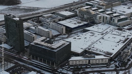 Aerial footage, ASML company grounds, building facades with ASML logos, cleanrooms, production halls, advanced semiconductor manufacturing facilities of the world’s leading EUV lithography supplier.