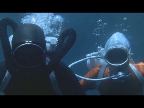 A frogwoman and a frogman in vintage scuba gear...and weird rubber monsters!