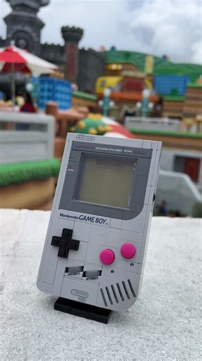 Ashnflash on Instagram: "I took the upcoming new LEGO Nintendo Gameboy set to Super Nintendo World at Universal Orlando! Such an awesome build, just the functionality with all the buttons and switches. The lenticular screen is so strange in person! The stand and swappable game cartridges are so fun! Hopefully we see a Legend of Zelda land join Donkey Kong and Mario here soon! Thanks to LEGO / LAN for sending me the Gameboy early! #lego #nintendo #mario #legonintendo #legosupermario #supermario #