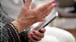 Nurse teaching elder woman how to use mobile phone, senior grandmother learning to use smartphone at nursing home. Modern technology for elderly. High quality 4k footage.