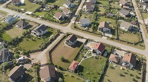 Aerial footage over a classica European housing estate, homes from above. Aerial shot over the top of housing estate. Aerial view over the village. Video without color correction 4K