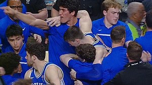Duke's Kyle Filipowski helped off after Wake Forest fans storm the court