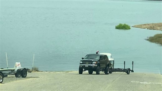 Driver struggles to back boat trailer into the lake