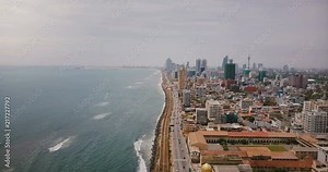 Amazing aerial view of Colombo, Sri Lanka. Drone flying over busy city street, ocean waves and modern Asian architecture