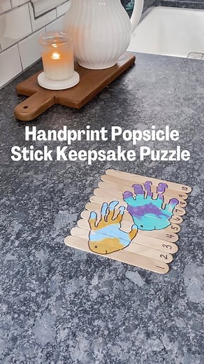 FISH HANDPRINT POPSICLE STICK KEEPSAKE PUZZLE! 🐠 Crafting memories, one handprint at a time! ✋ Dive into a seasonal kids’ craft activity with your preschoolers and create the Keepsake Popsicle Stick Puzzle! 🧩 You guys know I’m a complete sucker for handprints! Stamp your child’s little hands on a line of 10 popsicle sticks, transforming them into a seasonal picture. Then, number the sticks 1-10 and let the excitement begin as your child mixes up the order and skillfully puts the puzzle back to